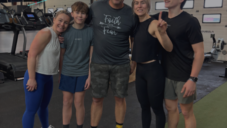 Active family smiling together inside City Fit Shop gym in Edmonton Alberta
