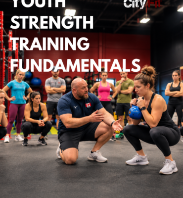 Coach teaching kettlebell squat technique during City Fit’s Youth Strength Training Fundamentals course for coaches in Edmonton.
